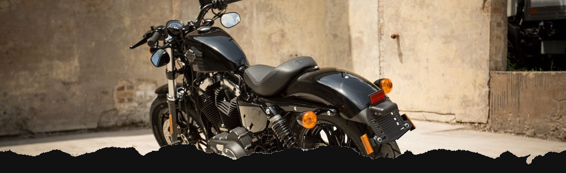 The rear view of a black Harley® motorcycle.